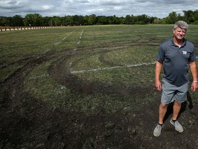 Winnipeg Rifles head coach Geordie Wilson shows the damage done to its practice field at Maple Grove Park in Winnipeg on Wed., Aug. 21, 2019. Kevin King/Winnipeg Sun/Postmedia Network