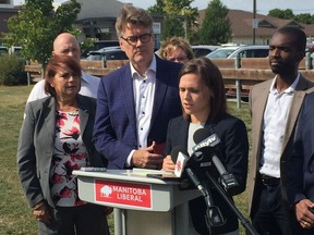 Manitoba Liberal Party Leader Dougald Lamont listens as Liberal candidate Cindy Lamoureux (Tyndall Park) speaks during a press conference in Winnipeg on Friday, to announce that a Manitoba Liberal government would build 1,200 affordable seniors' units and improve home care programs, something Liberals said Premier Brian Pallister promised in last election but didn't deliver.