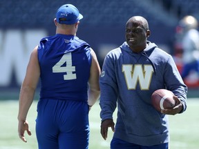 Defensive co-ordinator Richie Hall (right) passes linebacker Adam Bighill on his way to some teaching during Winnipeg Blue Bombers practice on Tues., July 2, 2019. Kevin King/Winnipeg Sun/Postmedia Network