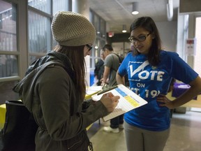 Rabbia Ashraf, vice-president internal at the Continuing Education Students' Association of Ryerson (CESAR) talks to 2nd year student Katey Agnitsch about voting on Oct, 7, 2015. Caro Loutfi is busy at her Montreal office putting together sources and organizing events to mobilize young Canadians to cast a ballot on Oct. 21. "If people aren't voting, democracy doesn't work" said Loutfi, the executive director of Apathy is Boring - a non-partisan organization that educate Canadian youth about democracy.