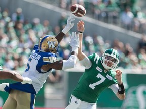 Saskatchewan Roughriders quarterback Cody Fajardo (7) throws a pass while being pressured by Willie Jefferson during the Labour Day Classic against the Winnipeg Blue Bombers at Mosaic Stadium.