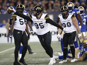 Hamilton Tiger-Cats' Julian Howsare celebrates his sack of Winnipeg Blue Bombers quarterback Chris Streveler during Friday's game. (THE CANADIAN PRESS)