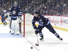 Winnipeg Jets defenceman Ville Heinola (36) skates past Winnipeg Jets goaltender Connor Hellebuyck (37) in the first period against the St. Louis Blues at Bell MTS Place on Friday. Heinola, the team's first-round pick (20th overall) back in June, hasn't looked out of place among men.