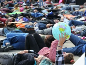 Climate change activists and students gather for a protest and "die-in" on the steps of the Calgary Municipal Building in Calgary on Friday, Sept. 20, 2019.