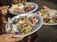 Members of the Hindu community eat vegetarian food at the Krishna Janmashtami festival at Bhaktivedanta Manor on Aug. 14, 2017 in Watford, England. (Rob Stothard/Getty Images)