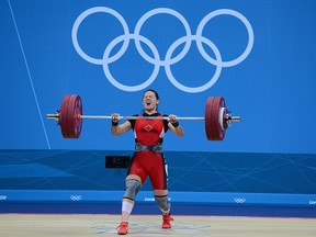 In this July 31, 2012, file photo, Christine Girard of Canada competes on her way to winning bronze during the Women's 63 kg Weightlifting final on Day 4 of the London 2012 Olympic Games at ExCeL on in London, England.