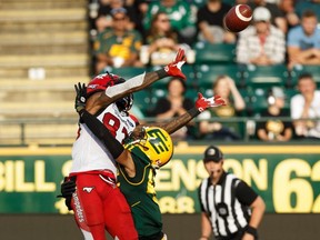 Eskimos' Monshadrik Hunter (right) blocks Stampeders' Josh Huff (left) during first half CFL action at Commonwealth Stadium in Edmonton, on Saturday, Sept. 7, 2019.