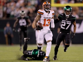 Cleveland Browns' Odell Beckham Jr., centre, breaks free from Brian Poole, left, and Darryl Roberts, right, of the New York Jets to run the ball 89 yards in for the touchdown in the third quarter at MetLife Stadium on Sept. 16, 2019 in East Rutherford, N.J. (Elsa/Getty Images)