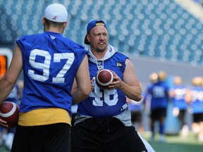 Blue Bombers long-snapper Chad Rempel (right) had to leave Sunday's game against the Saskatchewan Roughriders in the second quarter after taking a vicious hit from Lavar Edwards. (Kevin King/Winnipeg Sun)