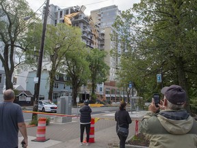 A toppled building crane is draped over a new construction project in Halifax on Sunday, Sept. 8, 2019. Hurricane Dorian brought wind, rain and heavy seas that knocked out power across the region, left damage to buildings and trees as well as disruption to transportation. More than 400,000 people are without electricity across the Maritimes this morning as post-tropical storm Dorian left behind a tangled mess of splintered trees and downed power lines before moving on to western Newfoundland.