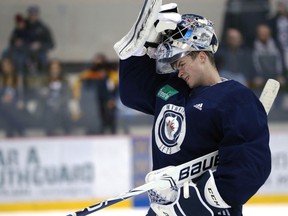 Eric Comrie puts his mask back on during Winnipeg Jets practice at Bell MTS Iceplex on Mon., April 8, 2019. Comrie is now with the Red Wings and will face his former team tonight.
Kevin King/Winnipeg Sun/Postmedia Network file