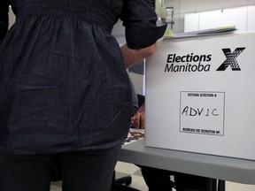 A woman prepares to cast an advance vote at the returning office at Corydon Community Centre's Crescentwood site on Corydon Avenue in Winnipeg on Wed., Sept. 4, 2019. Kevin King/Winnipeg Sun/Postmedia Network