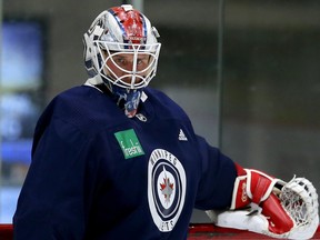 Goaltender Adam Carlson holds the net during Winnipeg Jets rookie camp at Bell MTS Iceplex in Winnipeg on Thurs., Sept. 5, 2019. Kevin King/Winnipeg Sun/Postmedia Network