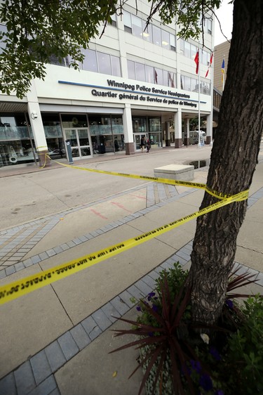 Police tape surrounds a portion of the Winnipeg Police Service headquarters along Graham Avenue, which was hit with a stray bullet from a shooting in the backlane of the 200 blocks of Smith and Garry streets in Winnipeg on Thurs., Sept. 12, 2019. Kevin King/Winnipeg Sun/Postmedia Network