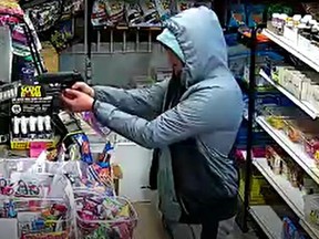 A screenshot from surveillance video believed to show the suspect in an Aug. 27 robbery of a convenience store in Winnipeg. The owners of the small family-run convenience store are pleading with the Winnipeg Police for help after a recent string of armed robberies that they claim were carried out by the same person and has left them fearing for their safety.