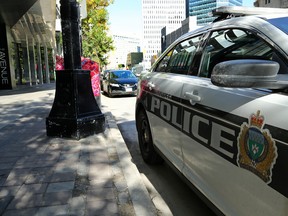 A police vehicle sits outside The Avenue apartment block on Portage Avenue in Winnipeg on Sun., Sept. 15, 2019. The building is believed to be the scene of early morning violence. Kevin King/Winnipeg Sun/Postmedia Network