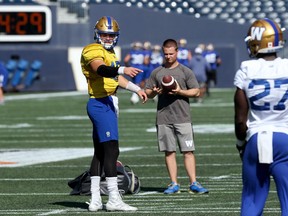 Chris Streveler (left) positions a running back during Winnipeg Blue Bombers practice at IG Field on Tuesday.