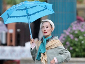 A woman uses an ornate umbrella while walking in the rain at The Forks, in Winnipeg. Saturday.