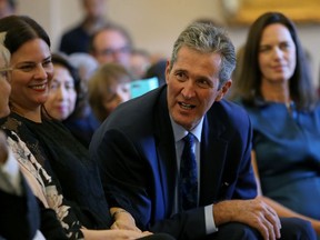 Premier Brian Pallister speaks to a member of the Progressive Conservative caucus during a swearing-in ceremony at the Manitoba Legislative Building in Winnipeg on Wed., Sept. 25, 2019. Kevin King/Winnipeg Sun/Postmedia Network