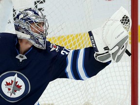 Winnipeg Jets goaltender Connor Hellebuyck makes a glove save during NHL pre-season action against the Edmonton Oilers at Bell MTS Place in Winnipeg on Thurs., Sept. 26, 2019. Kevin King/Winnipeg Sun/Postmedia Network