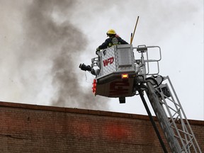 Winnipeg Fire Paramedic Service crews work to contain an early-morning fire in a historic, seven-storey building at 138 Portage Avenue East in downtown Winnipeg on Sunday.