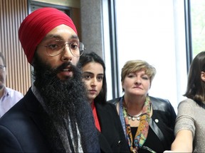 Simarpreet Singh addresses the media regarding a motion that will come to council on Oct. 24 to support the opposition to Quebec's Bill 21 as Imreet Kaur VP Central, World Sikh Organization of Canada and Coun. Janice Lukes  look on at Winnipeg City Hall on Wednesday, Oct. 16, 2019. Josh Aldrich/Winnipeg Sun/Postmedia