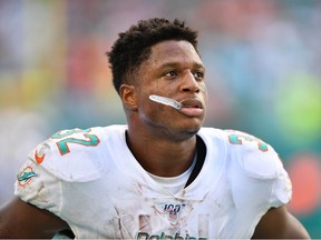 Kenyan Drake of the Miami Dolphins looks on from the sidelines after dropping the two point conversion against the Washington Redskins in the fourth quarter at Hard Rock Stadium on October 13, 2019 in Miami, Florida.