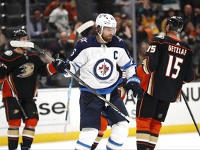 ANAHEIM, CALIFORNIA - OCTOBER 29:  Blake Wheeler #26 of the Winnipeg Jets looks on as Ryan Getzlaf #15 congratulates Carter Rowney #24 of the Anaheim Ducks on his empty net goal during the third period of a game at Honda Center on October 29, 2019 in Anaheim, California.   The Anaheim Ducks defeated the Winnipeg Jets 7-4. (Photo by Sean M. Haffey/Getty Images)