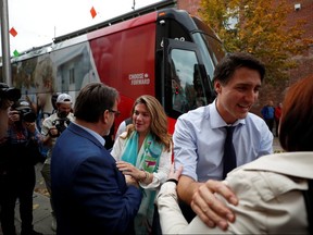 Liberal Leader Justin Trudeau and his wife Sophie Gregoire Trudeau campaign in Saint-Hyacinthe, Que., on Oct. 16, 2019. (REUTERS)