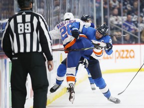 Winnipeg Jets' Blake Wheeler collides with Islanders' Oliver Wahlstrom (26) during second period action on Thursday night. THE CANADIAN PRESS/John Woods