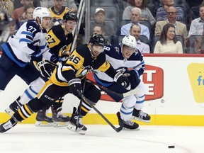 Pittsburgh Penguins center Zach Aston-Reese (46) chases against Winnipeg Jets center Andrew Copp (9) during the third period at PPG PAINTS Arena on Tuesday. Winnipeg won 4-1.Charles LeClaire-USA TODAY Sports