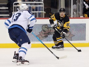 Oct 8, 2019; Pittsburgh, PA, USA; Pittsburgh Penguins center Sidney Crosby (87) carries the puck against Winnipeg Jets defenseman Carl Dahlstrom (23) during the second period at PPG PAINTS Arena. Winnipeg won 4-1. Charles LeClaire/USA TODAY Sports