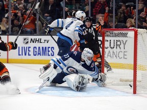 Jets goaltender Connor Hellebuyck lets a goal past him against the Ducks in Anaheim last night.  USA TODAY Sports