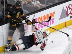 LAS VEGAS, NV - MAY 28:  Luca Sbisa #47 of the Vegas Golden Knights and Andre Burakovsky #65 of the Washington Capitals crash into the boards in the second period of Game One of the 2018 NHL Stanley Cup Final at T-Mobile Arena on May 28, 2018 in Las Vegas, Nevada. The Golden Knights defeated the Capitals 6-4.  (Photo by Ethan Miller/Getty Images)