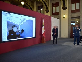 Mexico's Secretary of Defence Luis Sandoval and Mexico's President Andres Manuel Lopez Obrador show video footage when Mexican military forces briefly captured Ovidio Guzman, son of kingpin Joaquin "El Chapo" Guzman, during a news conference at National palace in Mexico City, Mexico Oct. 30, 2019.