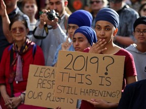 People protest Quebec's new Bill 21, which will ban teachers, police, government lawyers and others in positions of authority from wearing religious symbols such as Muslim head coverings and Sikh turbans, in Montreal, on June 17, 2019.