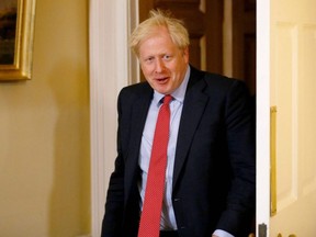Britain's Prime Minister Boris Johnson prepares to greet European Parliament president David Sassoli prior to a private meeting at 10 Downing Street in London on Tuesday, Oct. 8, 2019.
