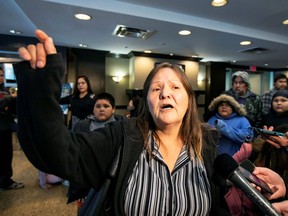 Margaret Missyabit from Lake Manitoba First Nations waits to be relocated after she was evacuated due to snowstorm power outages and before Conservative Leader Andrew Scheer makes an announcement in Winnipeg on Monday.
