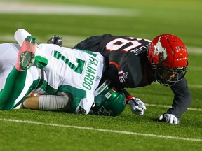 Saskatchewan Roughriders quarterback Cody Fajardo (7) is tackled by Royce Metchie of the Calgary Stampeders during Friday's CFL game.