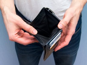 A man holding an empty wallet