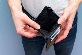 A man holding an empty wallet