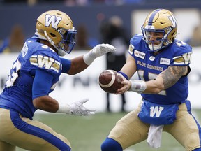Blue Bombers’ Andrew Harris (left) takes a hand-off from quarterback Chris Streveler during the first half against the Montreal Alouettes on Saturday in Winnipeg. 
(JOHN WOODS/THE CANADIAN PRESS)