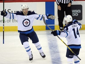Winnipeg Jets defenceman Neal Pionk (4) celebrates a goal against the New Jersey Devils during the third period at Prudential Center in Newark, N.J.