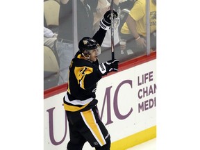 Pittsburgh, PA, USA; Pittsburgh Penguins center Evgeni Malkin (71) reacts after scoring a power play goal against the Buffalo Sabres during the second period at PPG PAINTS Arena.