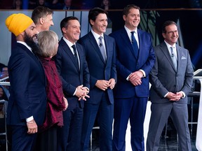 In this file photo taken on October 10, 2019 (from left) federal party leaders, Jagmeet Singh, Elizabeth May, Maxime Bernier, host Patrice Roy, Justin Trudeau, Andrew Scheer, and Yves-Francois Blanchet pose for pictures before their French language debate at the Canadian Museum of History in Gatineau, Quebec. (ADRIAN WYLD/POOL/AFP via Getty Images)