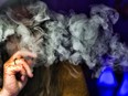 A woman takes a puff from a cannabis vape pen in Los Angeles on Dec. 22, 2018.