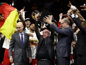 Raptors part-owner Larry Ranenbaum second from left) holds up the Larry OBrien Trophy after Toronto beat the Golden State Warriors in the NBA Finals. GETTY IMAGES