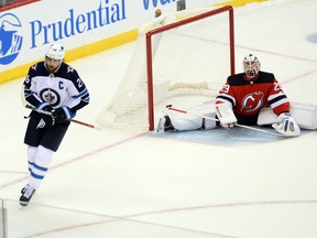 Jets right wing Blake Wheeler scores against Devils goaltender Mackenzie Blackwood last night in New Jersey. The Jets won 5-4 in a shootout. (USA Today)