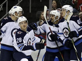 Jack Roslovic (28) of the Winnipeg Jets celebrates after scoring a goal during the third period against the New Jersey Devils at the Prudential Center on Friday in Newark, N.J.
