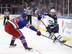 NEW YORK, NEW YORK - OCTOBER 03: Ville Heinola #14 of the Winnipeg Jets skates in his first NHL game against the New York Rangers at Madison Square Garden on October 03, 2019 in New York City. The Rangers defeated the Jets 6-4.